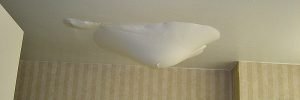 water being trapped on the ceiling by paint