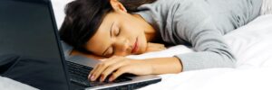 exhausted woman after looking at houses on computer
