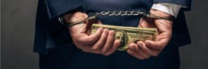 man in handcuffs with money who blindsided a closing