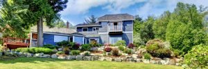 large blue house with well manicured lawn