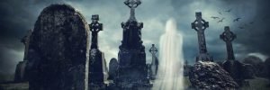 Spooky old graveyard and a ghost at night