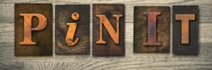 The words "PIN IT" written in wooden letterpress type.